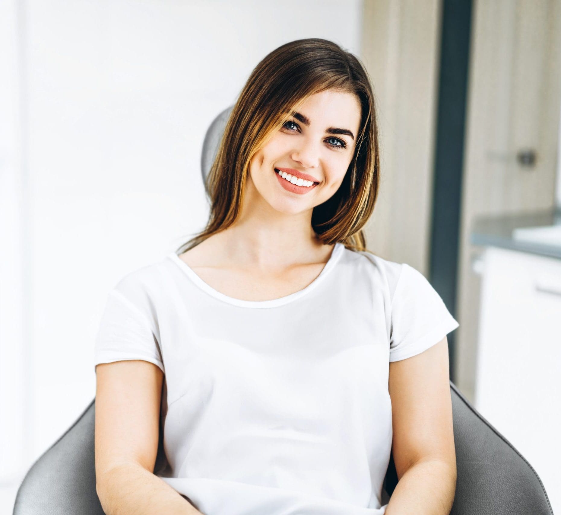 pretty-happy-and-smiling-dental-patient-sitting-in-the-dental-ch