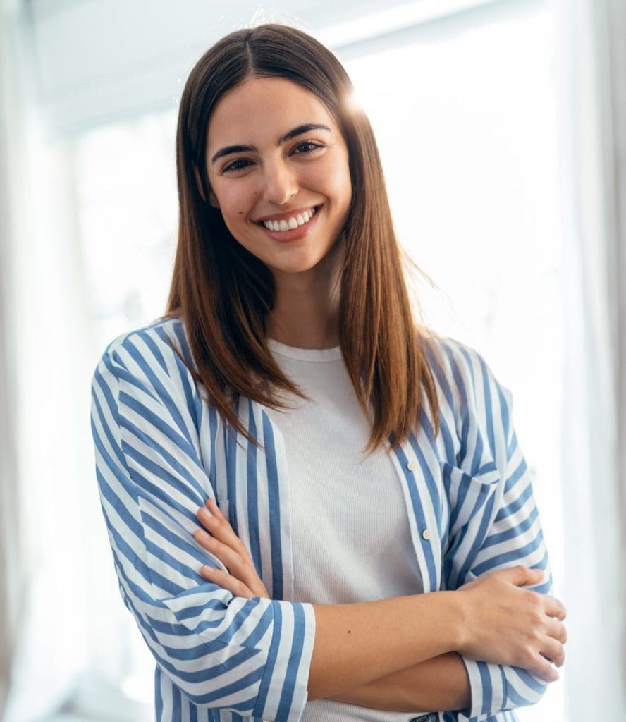 beautiful-smiling-woman-looking-at-camera-while-standing-in-livi